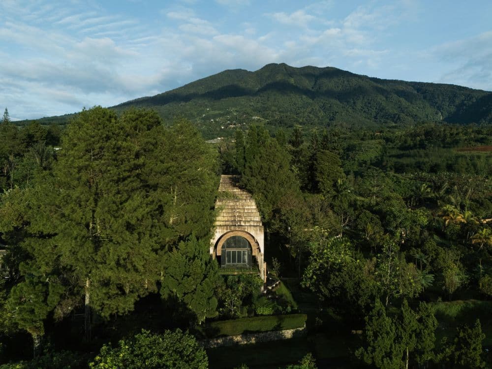 Sanctuary Tunnel Garden sits within the green landscape of Cigombong.