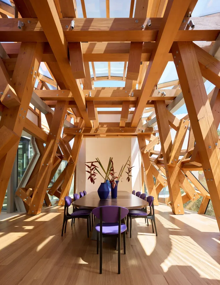 Interior view highlighting sweeping timber beams and Gehry’s signature curvilinear geometry. Image © Jason Schmidt