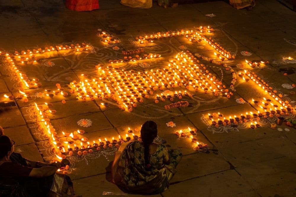 ecorated enlightened clay lamp (diya) at varanasi ganga ghat during dev diwali festival.