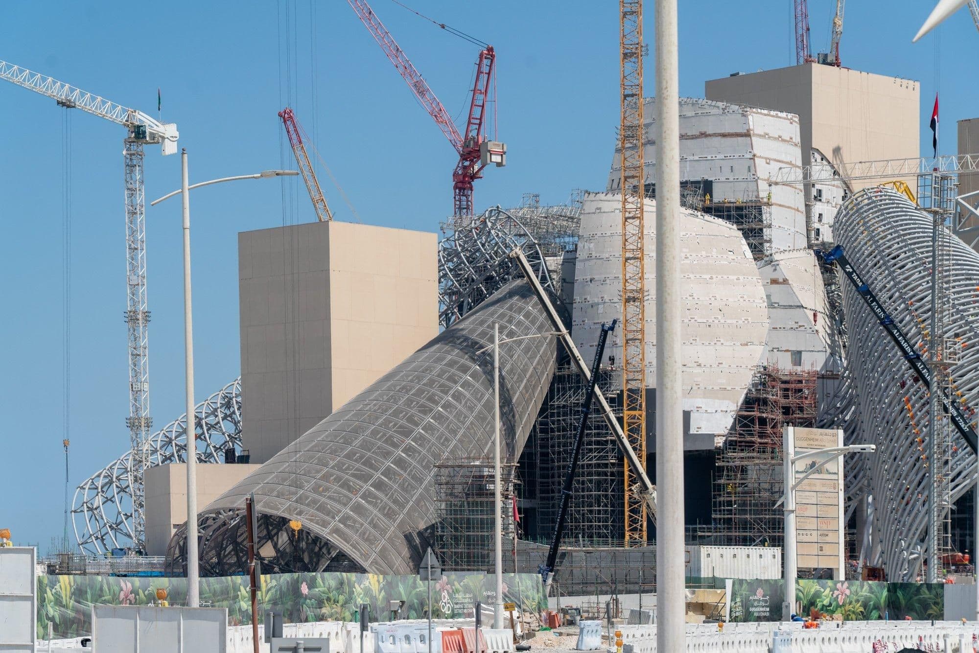 Construction work reveals the layered steel framework behind the museum’s curved forms.