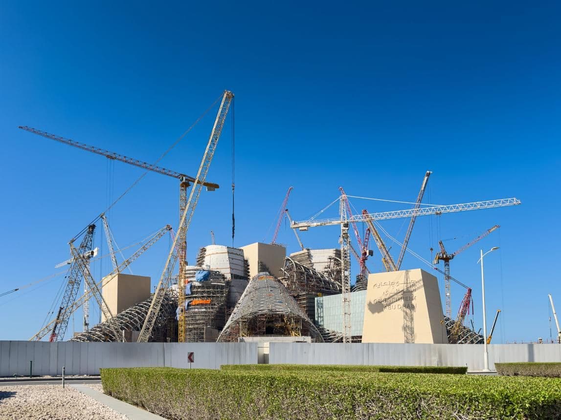Cranes surround Guggenheim Abu Dhabi as the museum’s complex forms take shape.