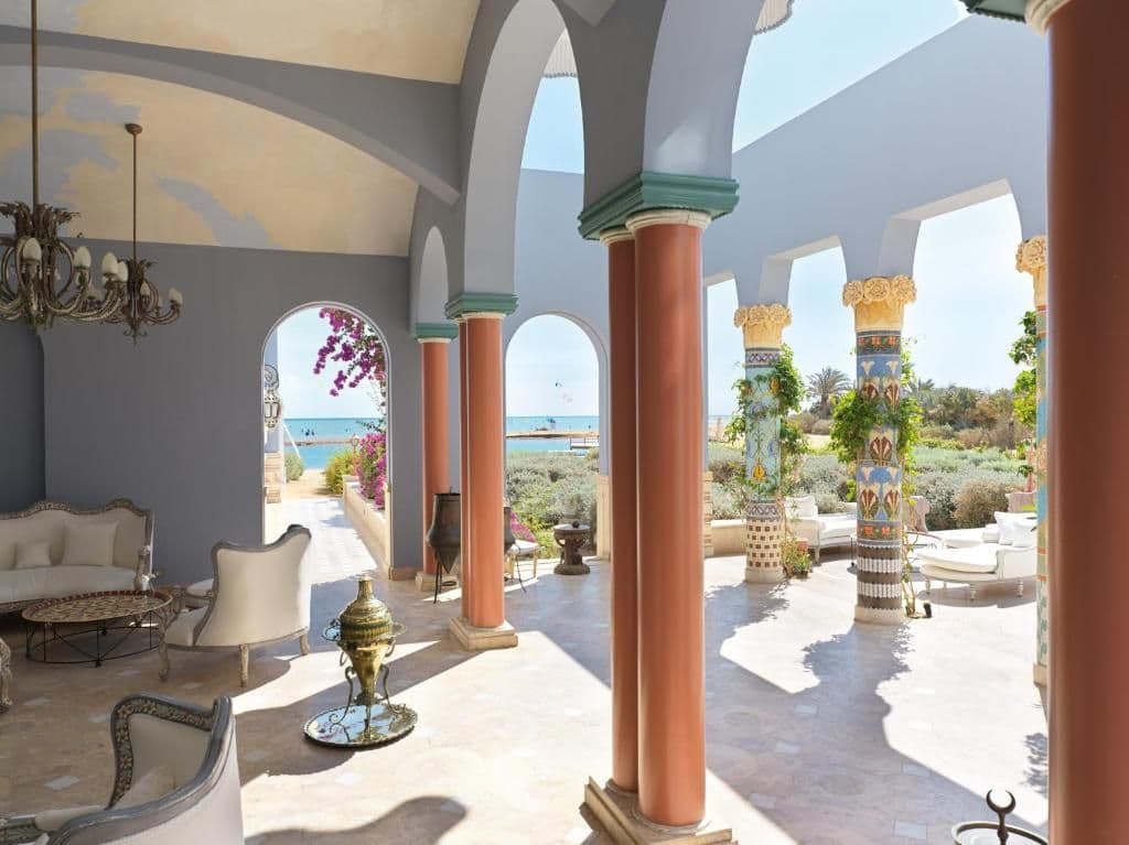 A sunlit terrace at La Maison Bleue offers uninterrupted views across Mangroovy Beach and the Red Sea beyond.