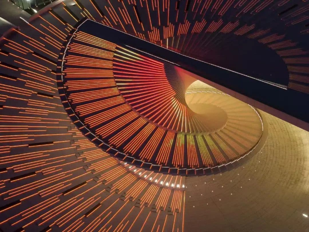 Lighting emphasises the sweeping geometry of the opera house’s double-helix staircase.