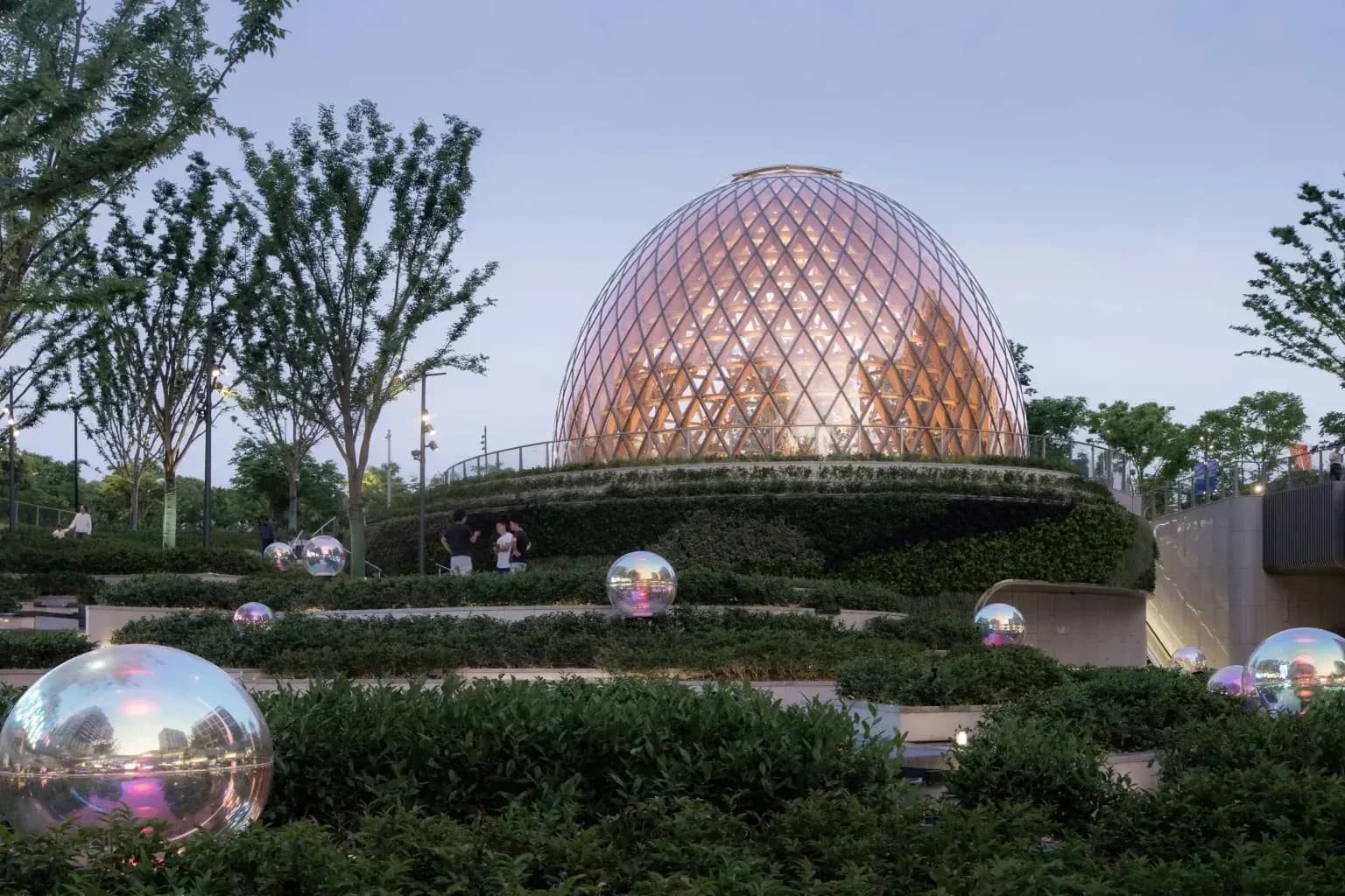 The Shanghai Riverside Seed Pavilion emerges from a terraced landscape along the city’s West Bund.
