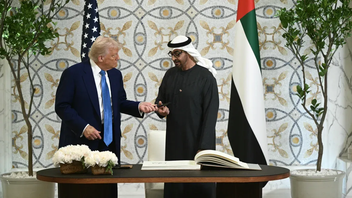 US President Donald Trump returns the pen to his UAE counterpart Sheikh Mohamed bin Zayed Al Nahyan