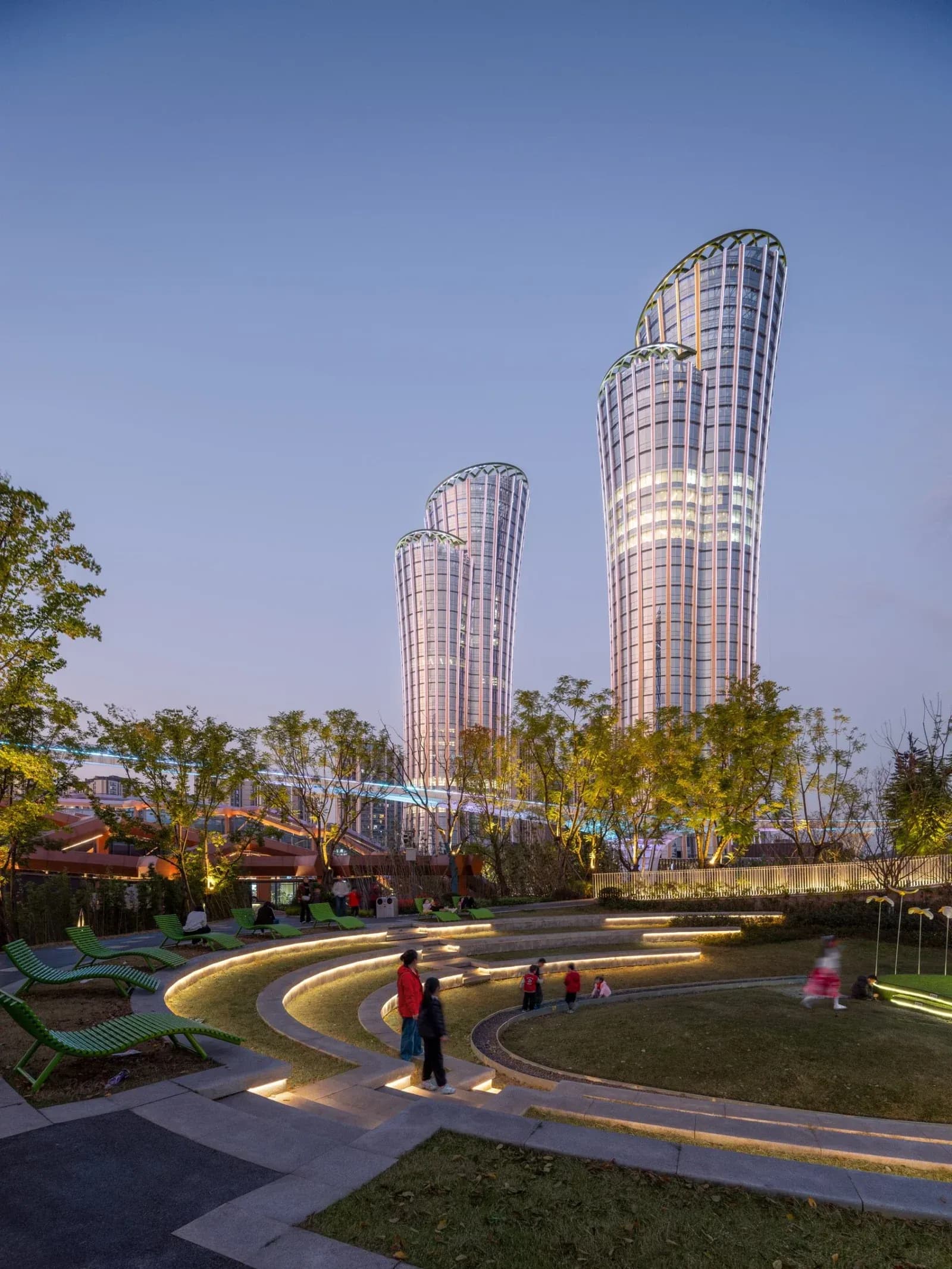Sculptural towers inspired by bamboo rise above a layered landscape of parks, terraces and civic spaces.