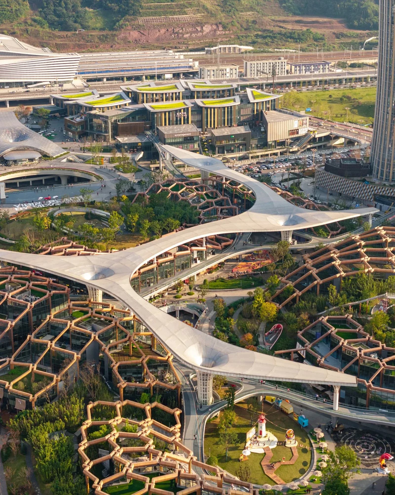 Sculptural towers inspired by bamboo rise above a layered landscape of parks, terraces and civic spaces.