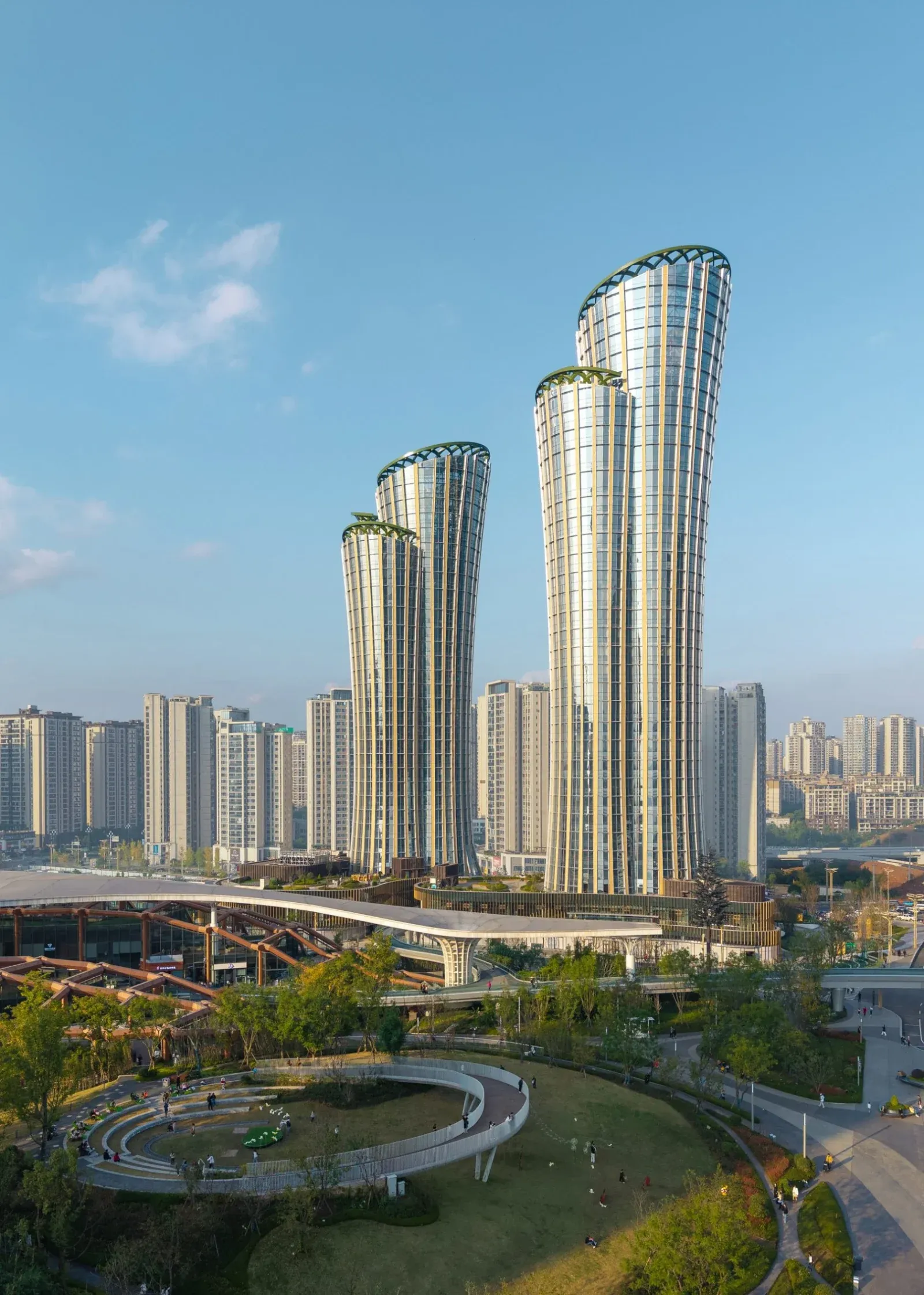 Sculptural towers inspired by bamboo rise above a layered landscape of parks, terraces and civic spaces.