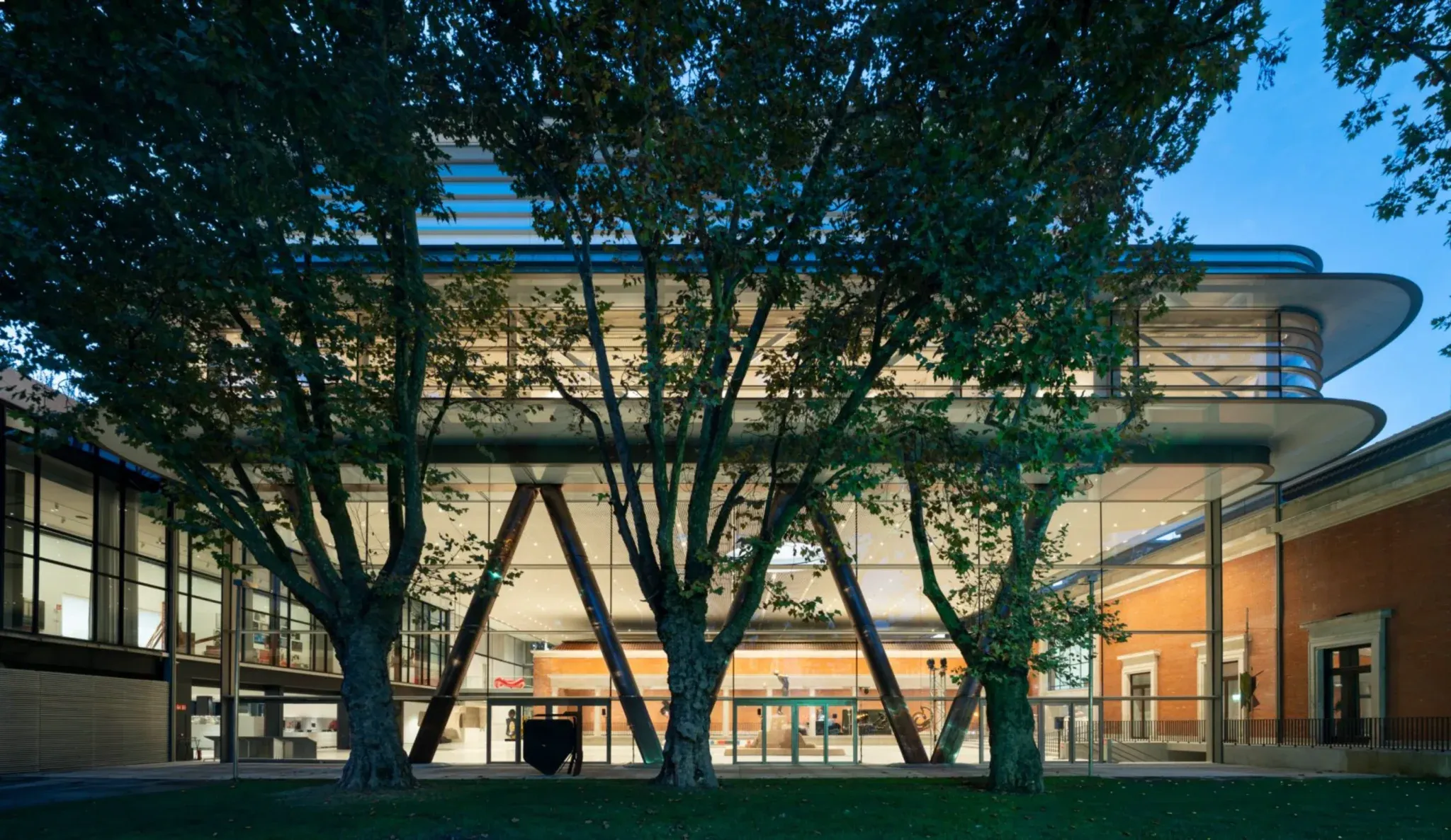 The new structure connects with the existing museum and surrounding park.