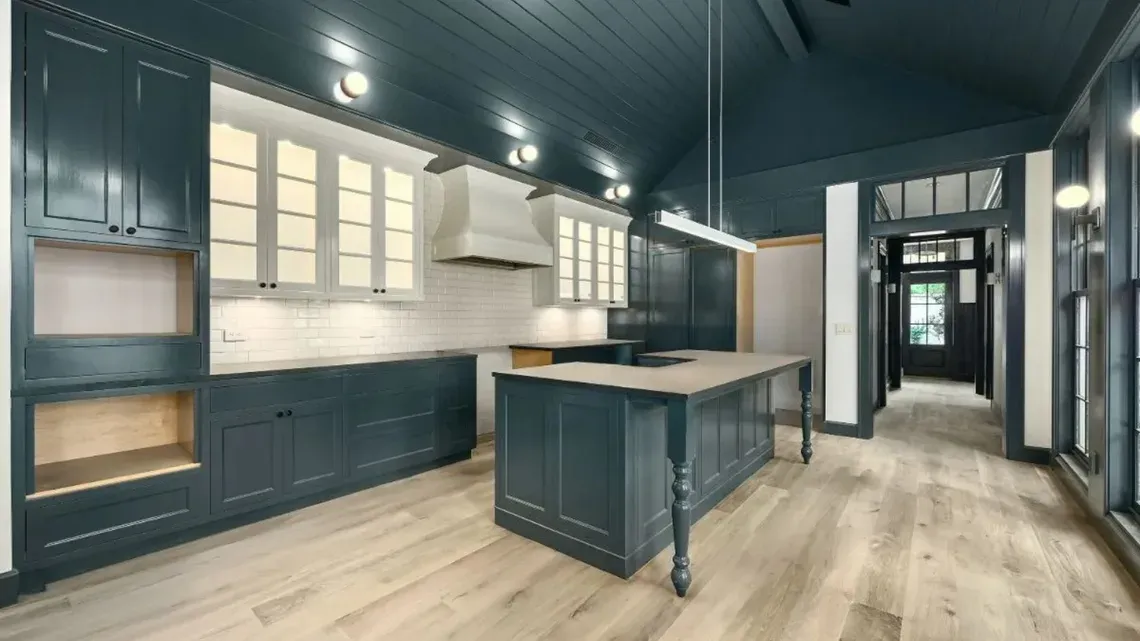 A navy-toned kitchen highlighted by a spacious island