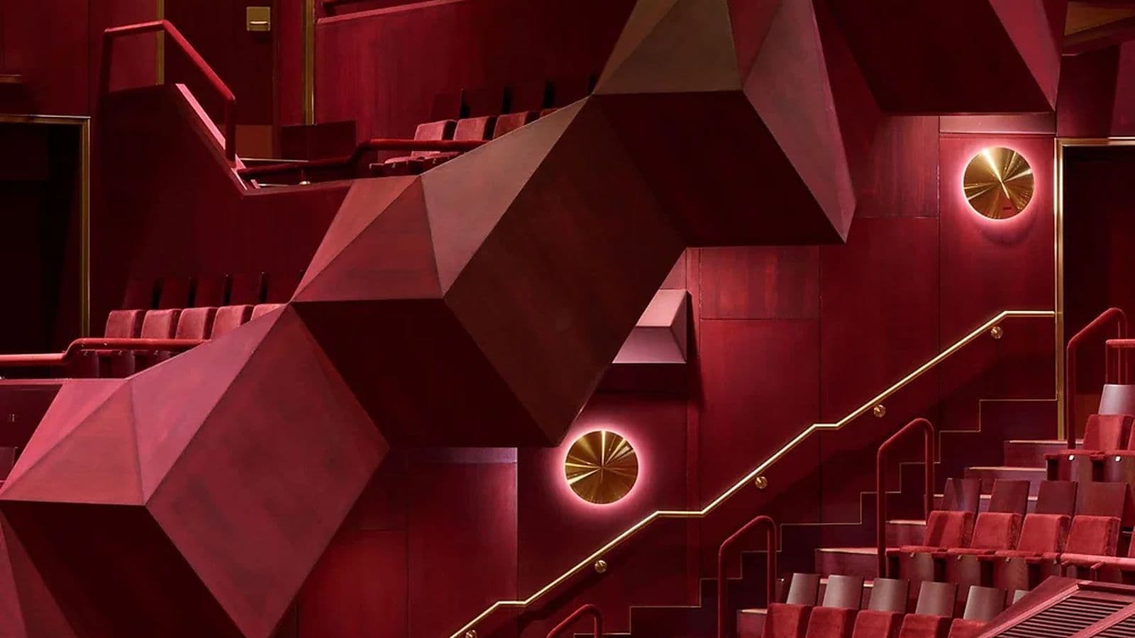 A closer view of the theatre’s tiered seating, geometric balcony forms and restored brass detailing.