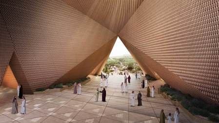 A vast triangular portal gathers worshippers in a shaded forecourt that connects the main boulevard with Wadi Hanifah.