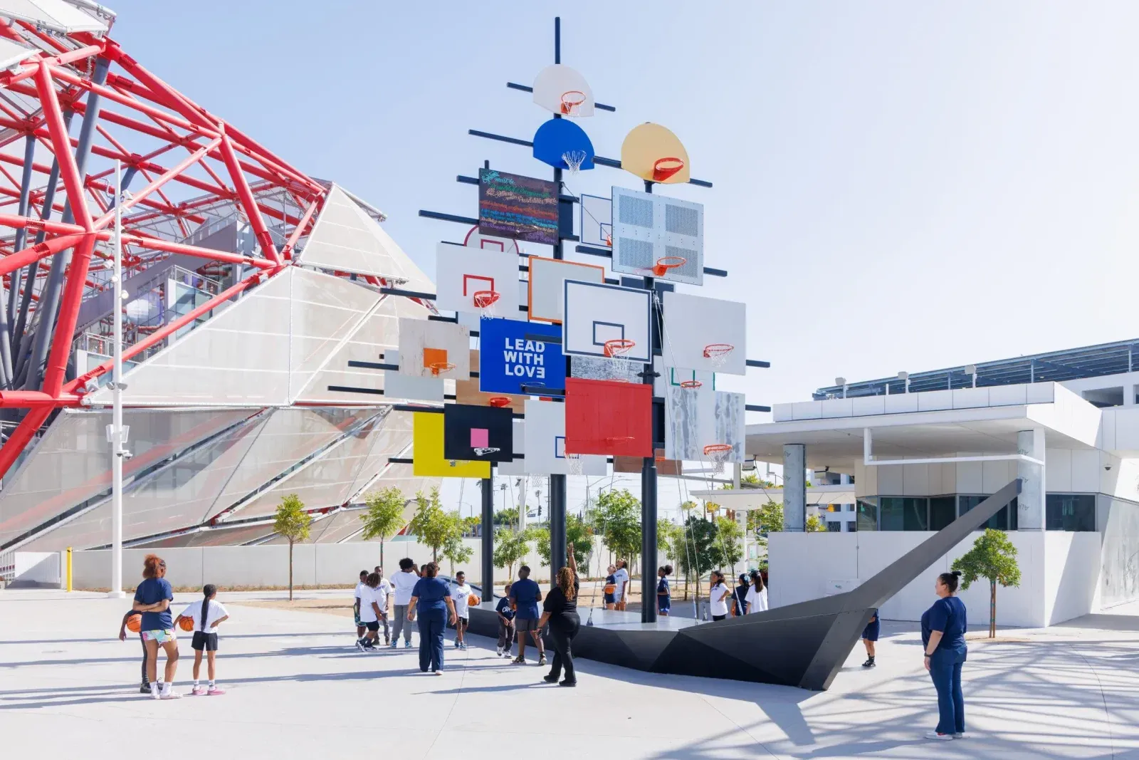 Community plaza at the Intuit Dome featuring basketball courts, a performance stage, and open public gathering areas.