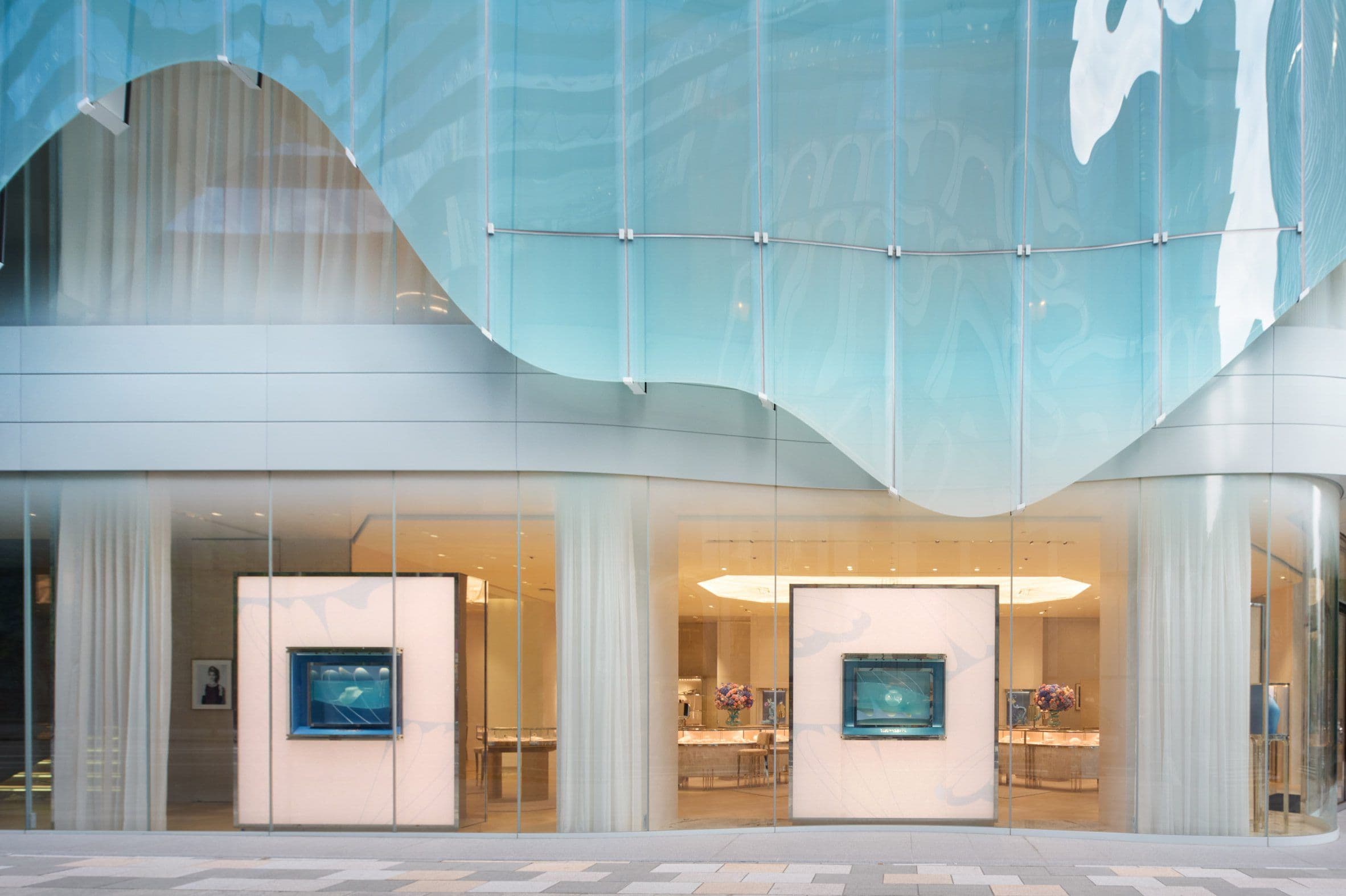 To prevent a blue tint from spilling inside, the studio employed a ceramic printing technique to filter light and maintain ideal illumination for product displays.