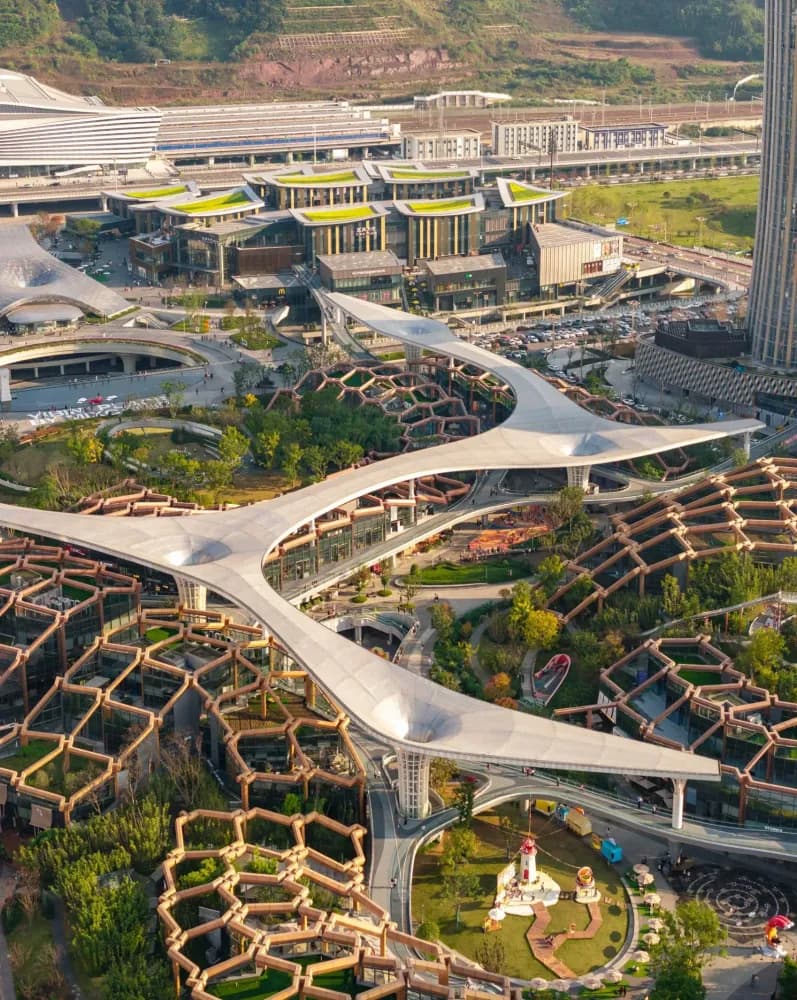 Sculptural towers inspired by bamboo rise above a layered landscape of parks, terraces and civic spaces.