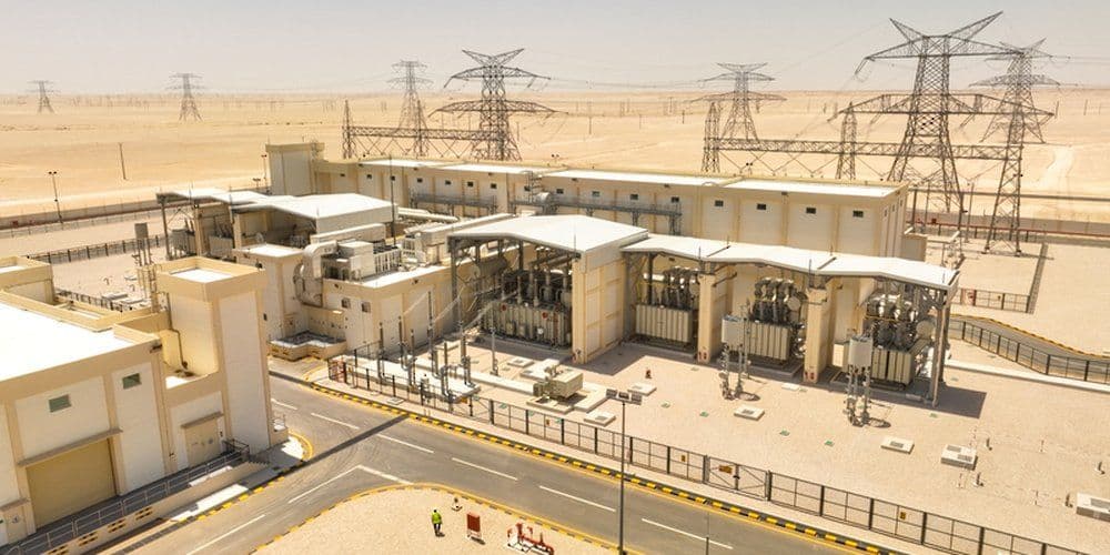 Aerial view of an electricity substation and overhead transmission lines in the desert, used by Oman News Agency with Nama Electricity Distribution’s investment announcement