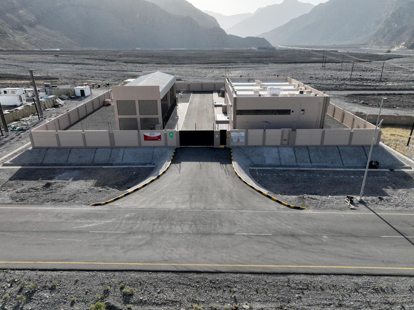 Walled Nama Electricity Distribution substation beside a road in a mountain valley in Oman