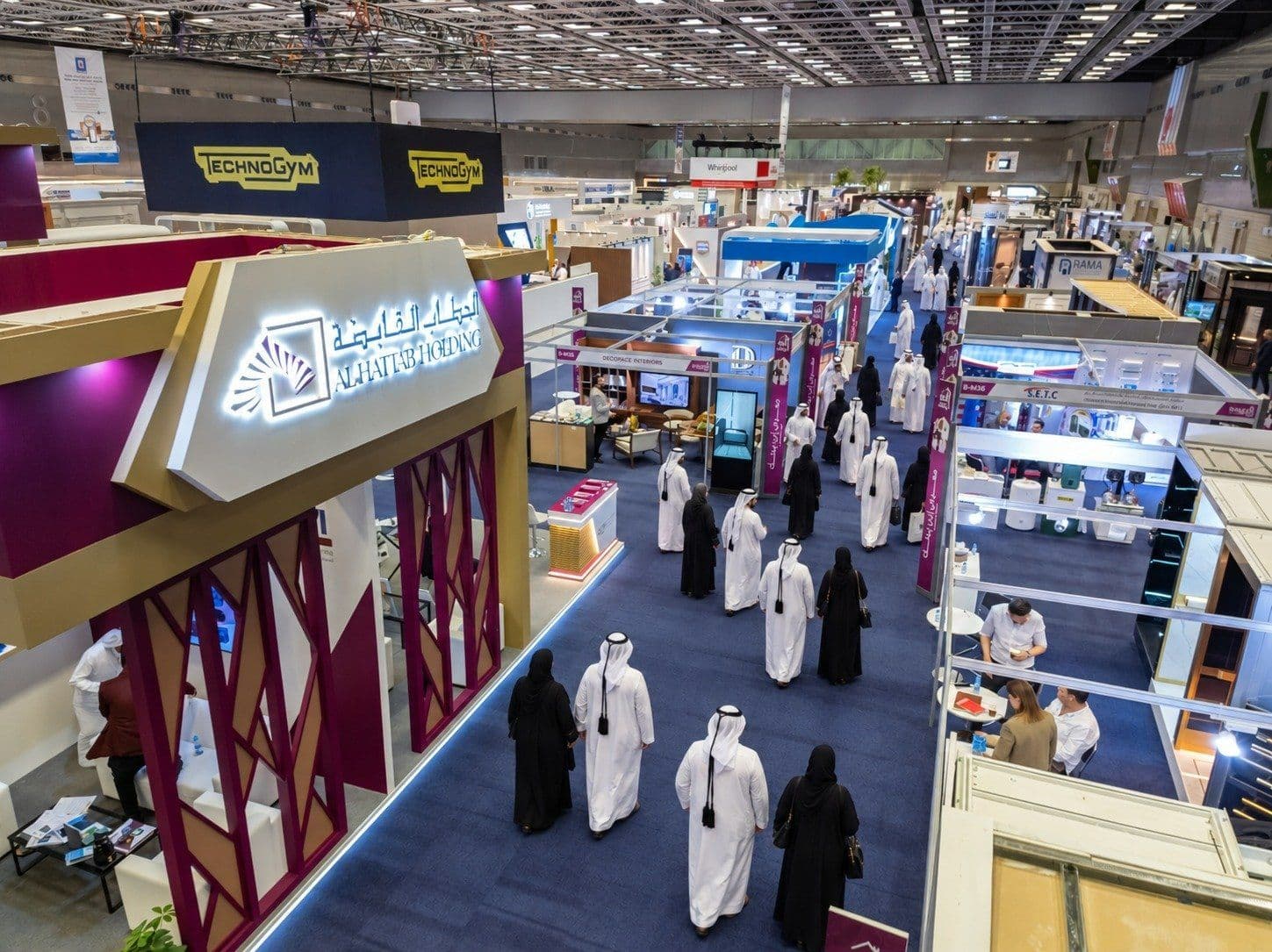 Visitors walking between exhibitor stands in the hall at a previous edition of Build Your House Exhibition in Doha