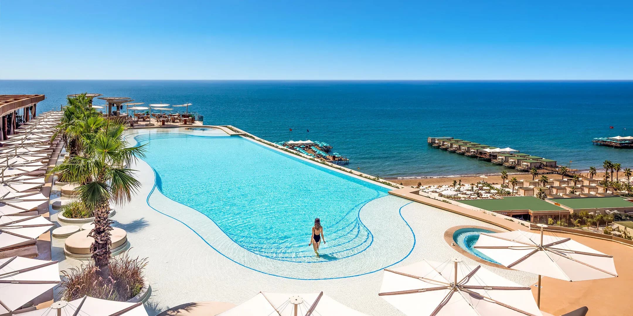 The rooftop includes an infinity pool, restaurant, bar and fitness club, with sunset views and private dining experiences.