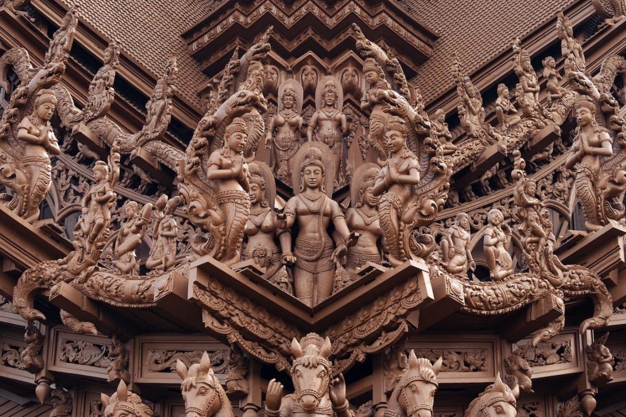 Carved deities, serpents and horses crowd a roof corner of the Sanctuary of Truth