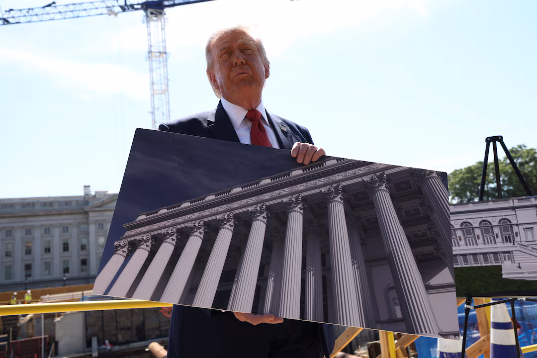 U..S. President Donald Trump shows an image of the concept at the site of ongoing construction of the planned White House ballroom in Washington, D.C., U.S., May 19, 2026. REUTERS/Kevin Lamarque